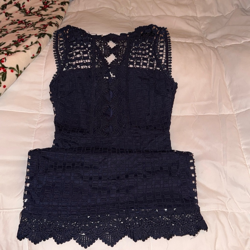 Navy blue tight fitted dress with low cut openings
Brand: Dress Forum
